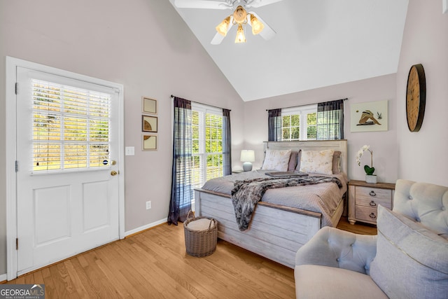 bedroom with light hardwood / wood-style floors, high vaulted ceiling, and ceiling fan