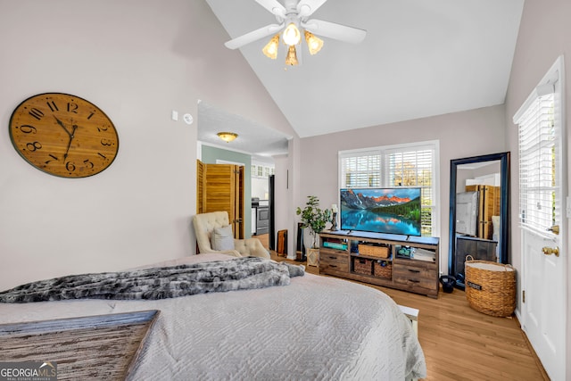 bedroom with light hardwood / wood-style floors, high vaulted ceiling, and ceiling fan