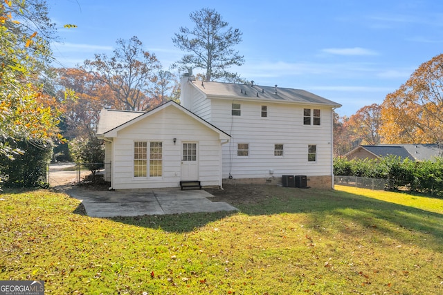 rear view of property with a yard and a patio