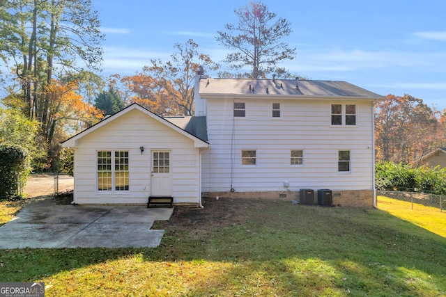 back of property featuring cooling unit, a patio area, and a yard