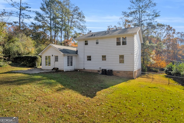 back of property featuring a yard, cooling unit, and a patio area