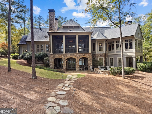 back of house with a sunroom