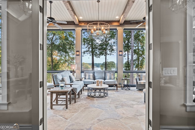 sunroom / solarium featuring beam ceiling, wooden ceiling, and ceiling fan with notable chandelier