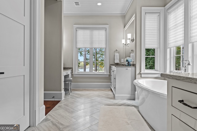 bathroom with parquet flooring, ornamental molding, vanity, and a tub