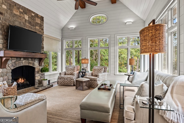 sunroom / solarium with ceiling fan, a fireplace, and lofted ceiling