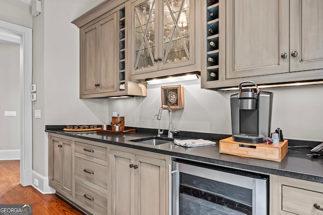 kitchen with dark hardwood / wood-style floors, light brown cabinets, sink, and beverage cooler