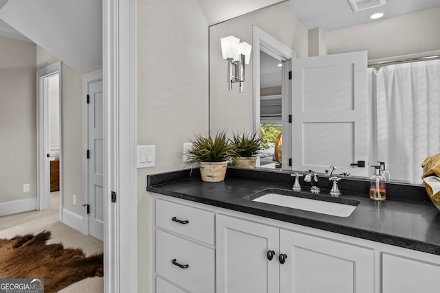 bathroom featuring a shower with shower curtain and vanity