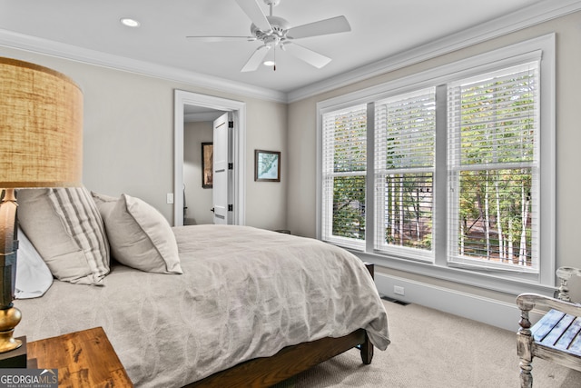 carpeted bedroom featuring ceiling fan and ornamental molding