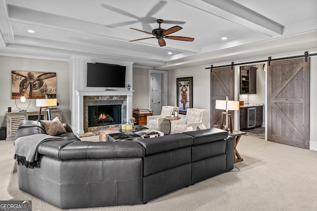 living room with light colored carpet, ceiling fan, beam ceiling, a barn door, and wine cooler