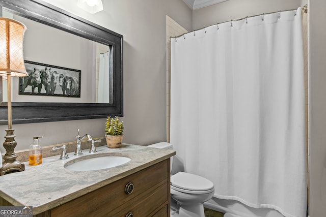 bathroom featuring crown molding, vanity, and toilet