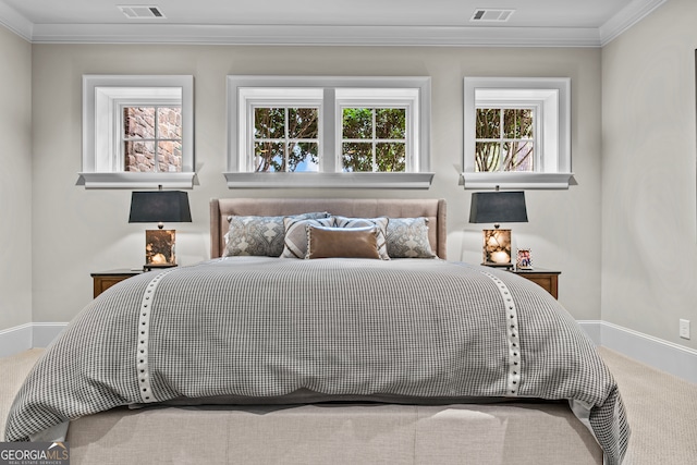 carpeted bedroom with ornamental molding and multiple windows