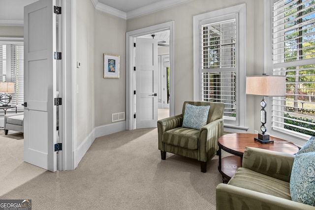 living area with light colored carpet and crown molding