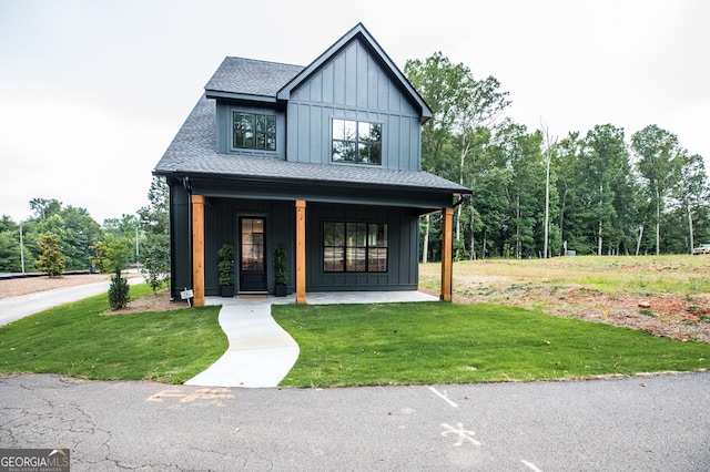 modern farmhouse featuring a porch and a front lawn