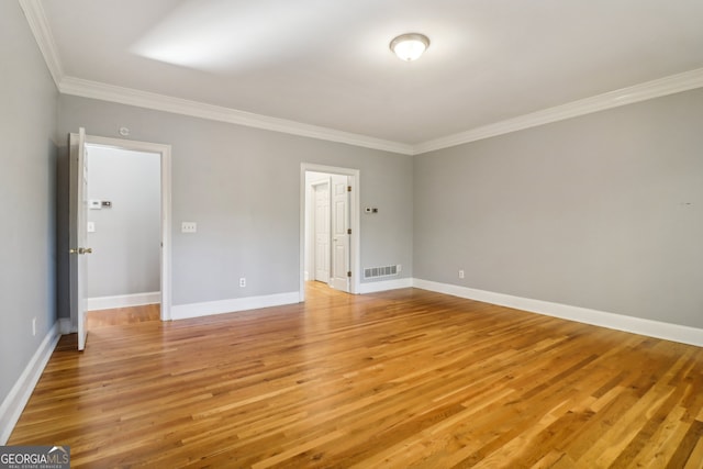 unfurnished room with light hardwood / wood-style floors and ornamental molding