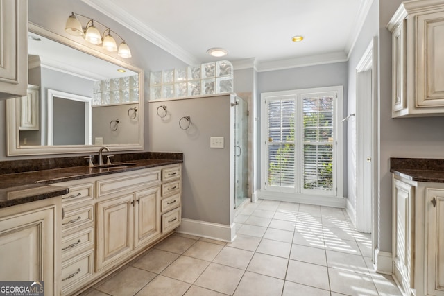 bathroom with tile patterned flooring, vanity, a shower with door, and ornamental molding