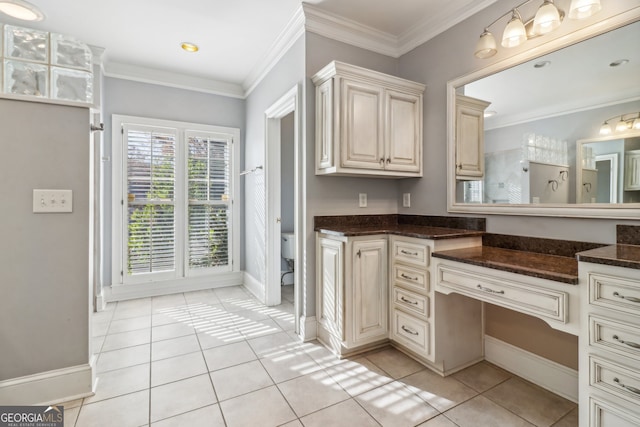 bathroom featuring tile patterned floors, vanity, toilet, and crown molding