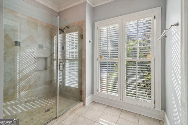 bathroom with tile patterned floors, a shower with shower door, and crown molding