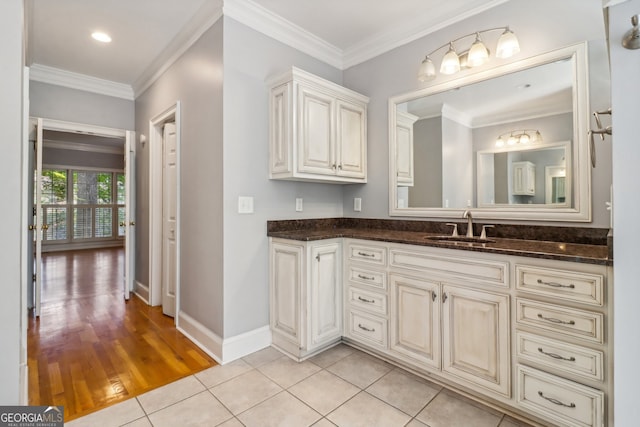 bathroom featuring hardwood / wood-style floors, vanity, and crown molding