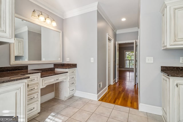 bathroom with crown molding, hardwood / wood-style floors, and vanity