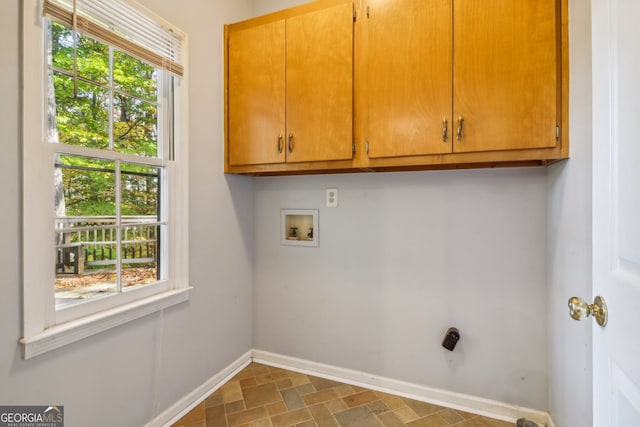 laundry area featuring washer hookup and cabinets