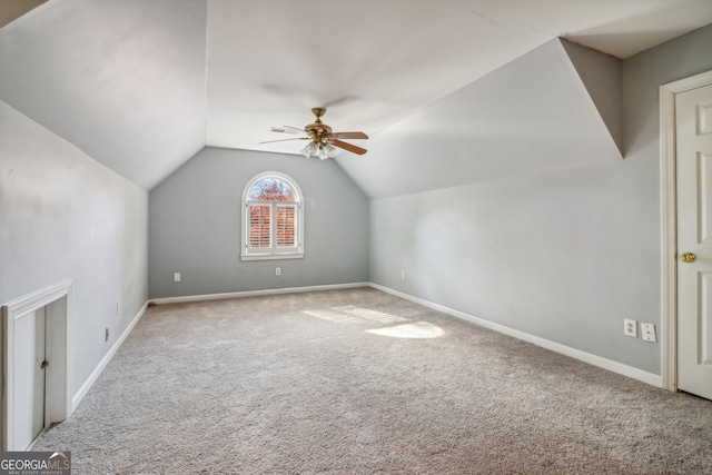 additional living space featuring ceiling fan, lofted ceiling, and light carpet