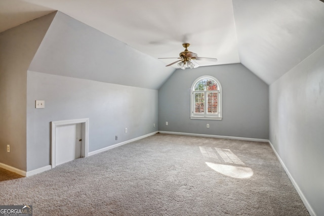 additional living space featuring light carpet, ceiling fan, and lofted ceiling