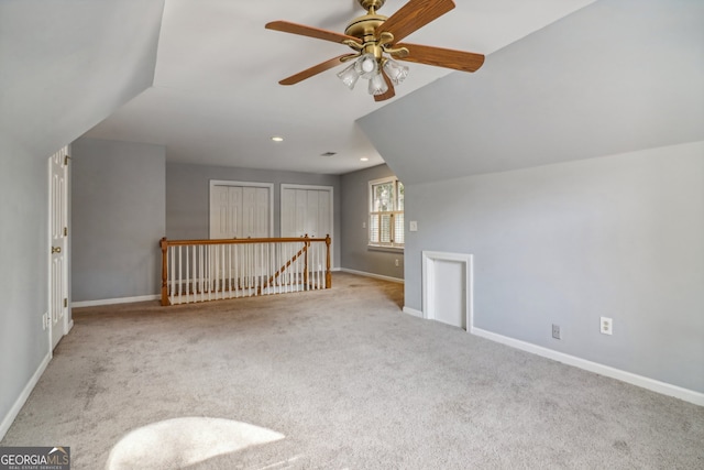 bonus room with ceiling fan, light colored carpet, and vaulted ceiling