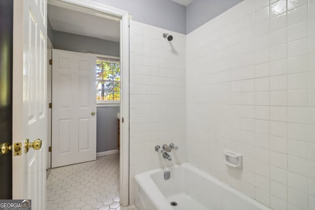 bathroom with tile patterned floors and tiled shower / bath combo