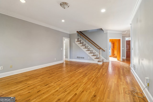 unfurnished living room with light hardwood / wood-style floors and ornamental molding