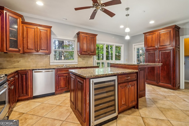 kitchen featuring stainless steel appliances, beverage cooler, tasteful backsplash, crown molding, and a kitchen island