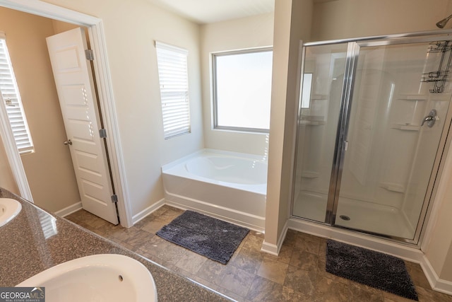 bathroom with vanity and shower with separate bathtub