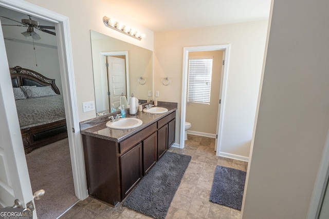 bathroom featuring ceiling fan, vanity, and toilet