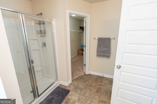 bathroom with a shower with door