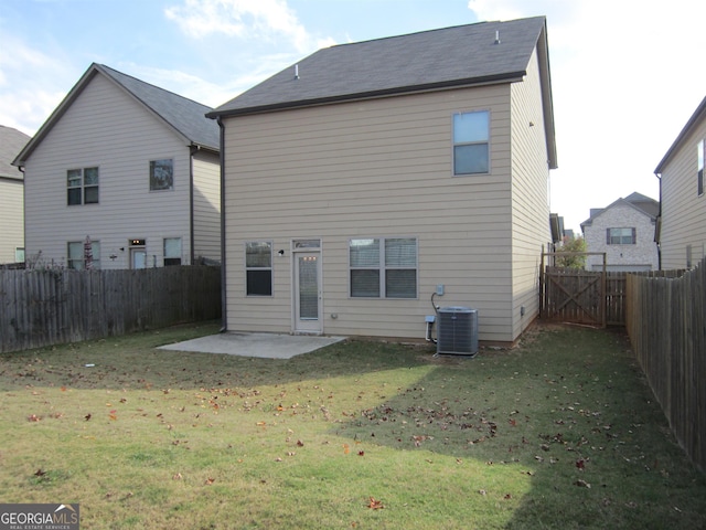 back of house with a yard, cooling unit, and a patio