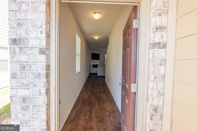 corridor with dark hardwood / wood-style flooring