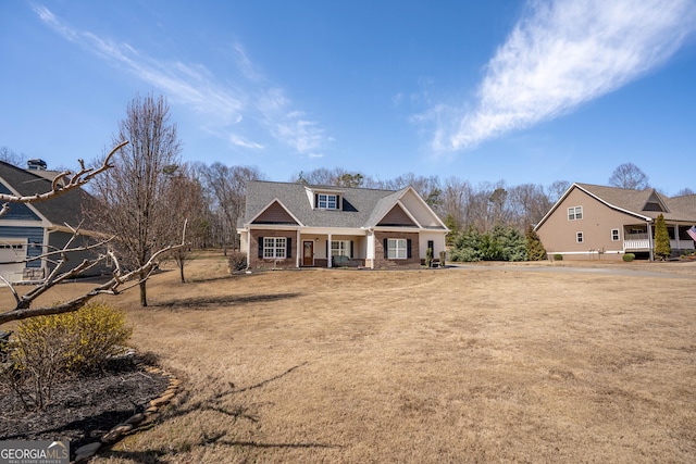 craftsman-style home with covered porch and a front yard