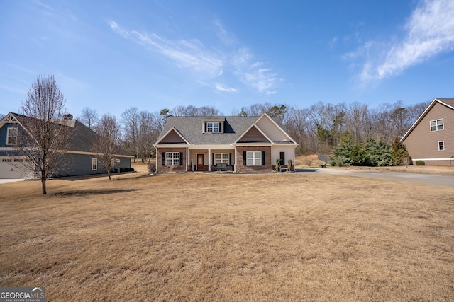 craftsman-style house with a porch and a front yard