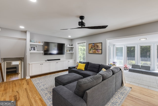 living room featuring light hardwood / wood-style floors and ceiling fan