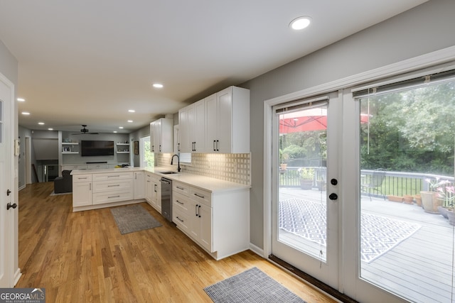 kitchen featuring white cabinets, sink, ceiling fan, light wood-type flooring, and tasteful backsplash