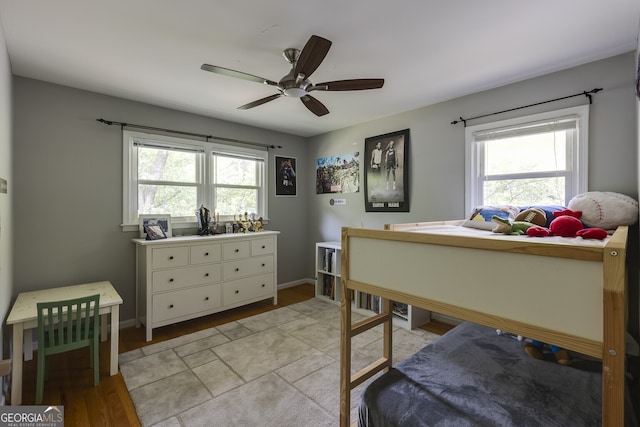 bedroom with ceiling fan and light hardwood / wood-style flooring