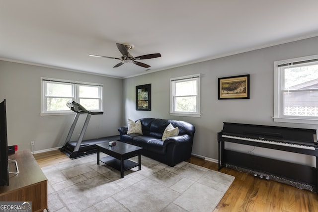 living room with ceiling fan, a healthy amount of sunlight, and light hardwood / wood-style flooring