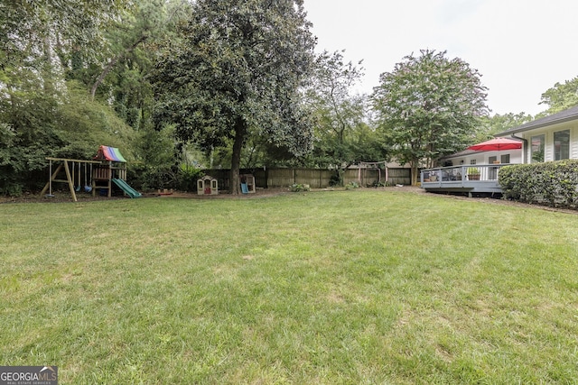 view of yard featuring a playground and a deck