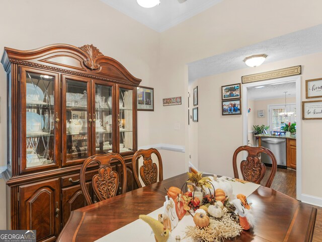 dining room featuring ceiling fan with notable chandelier, dark hardwood / wood-style flooring, and sink