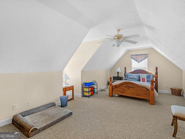 bedroom featuring a textured ceiling, carpet floors, vaulted ceiling, and ceiling fan