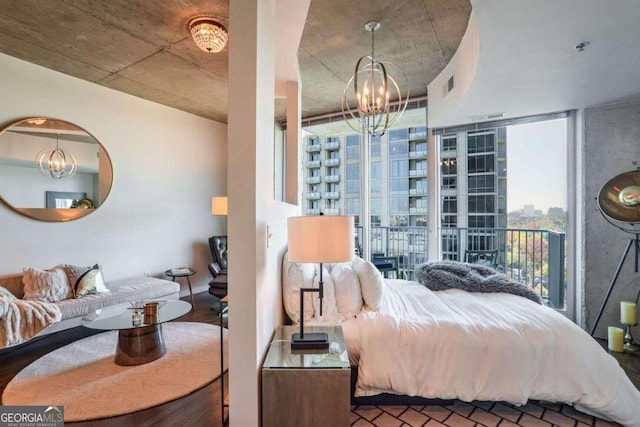 bedroom featuring hardwood / wood-style floors, expansive windows, and a chandelier