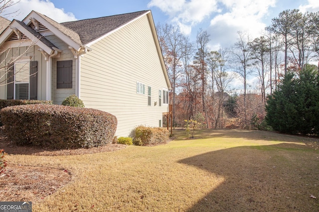 view of property exterior with a lawn