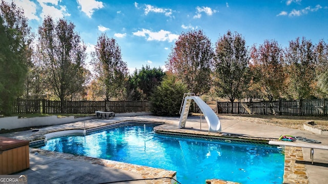 view of pool with a patio area and a water slide