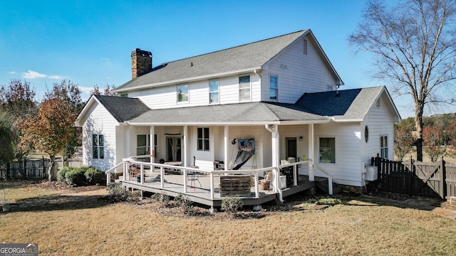 rear view of property with a yard