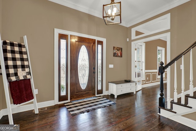 foyer featuring dark hardwood / wood-style flooring, a wealth of natural light, and crown molding