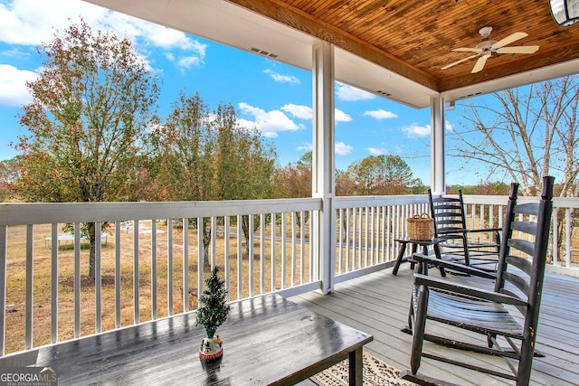 wooden deck featuring ceiling fan